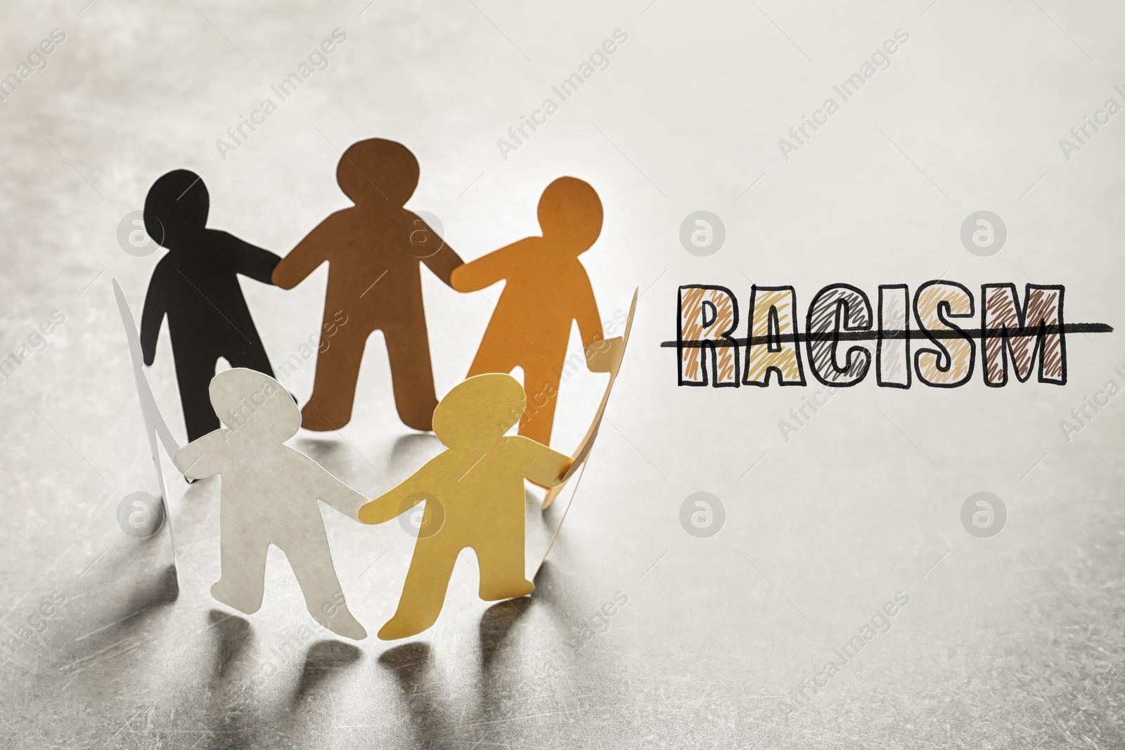 Image of Stop racism. Paper people in different colors holding hands and strikethrough word on light background