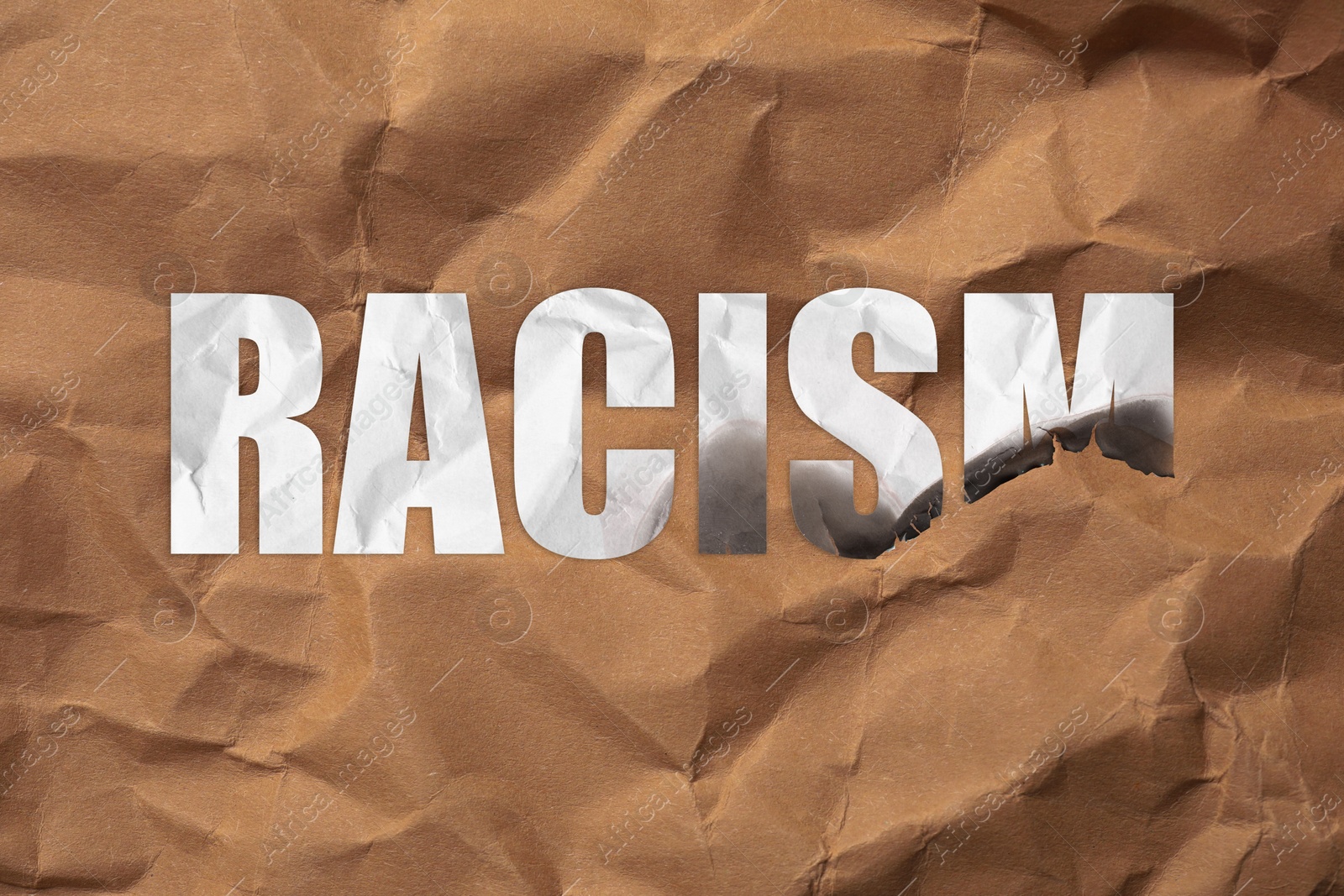 Image of Stop racism concept. Burnt word with crumpled paper texture inside