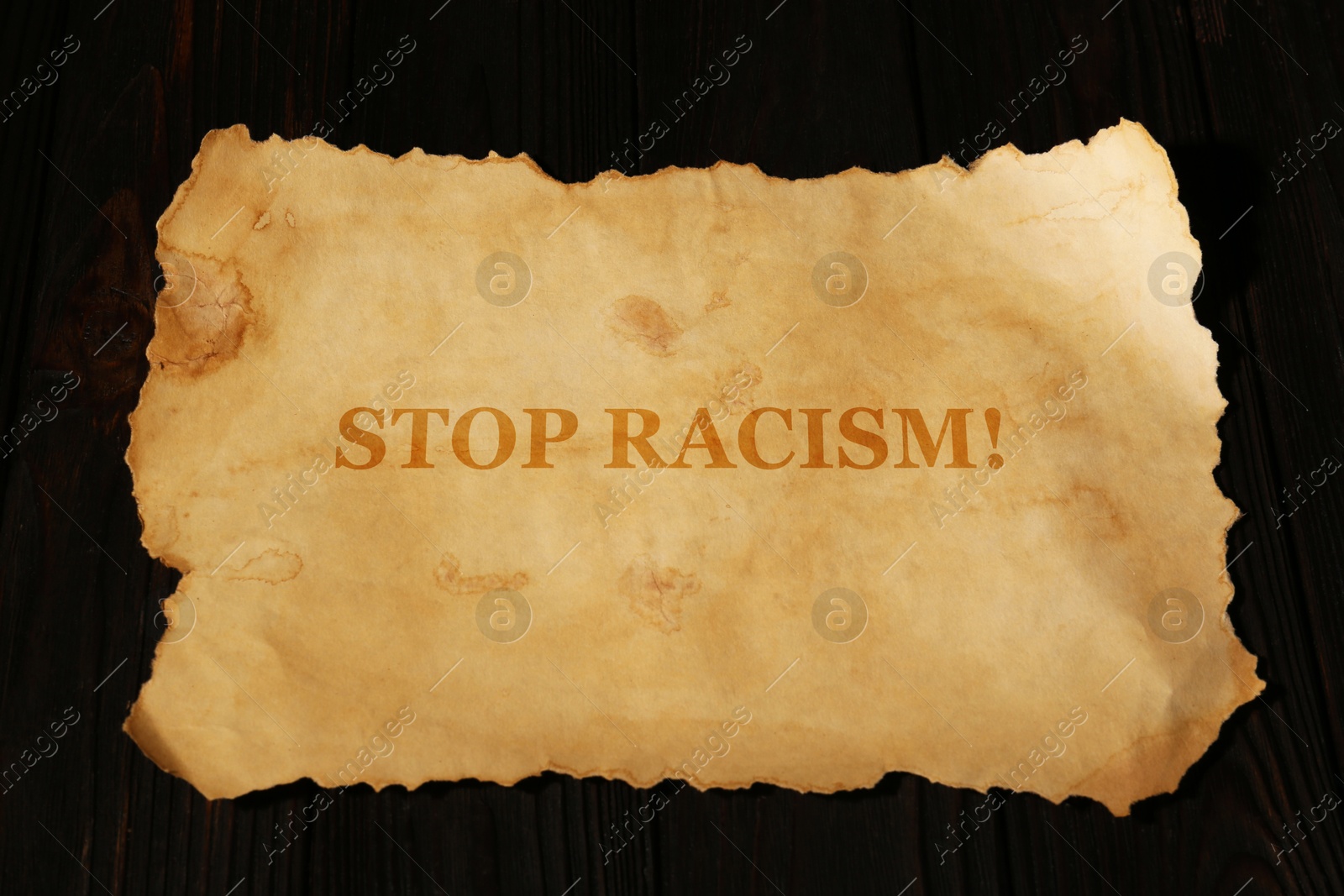 Image of Stop Racism. Old parchment paper with text on black background