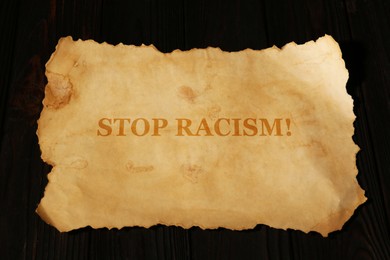 Image of Stop Racism. Old parchment paper with text on black background