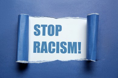 Image of Stop racism. View on text through torn blue paper