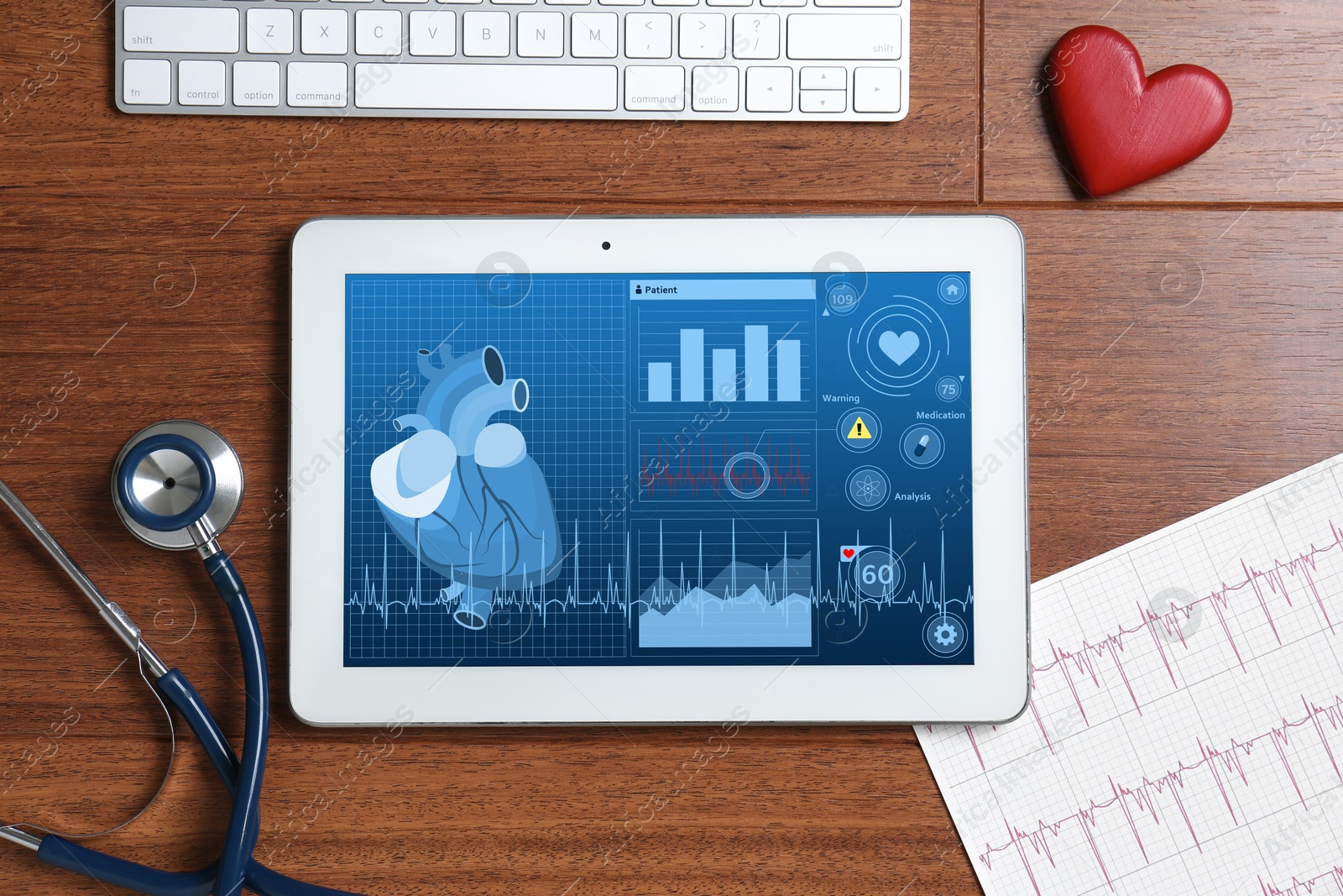 Image of Cardiology. Doctor's workplace with stethoscope and tablet computer on wooden table, top view. Data on device screen