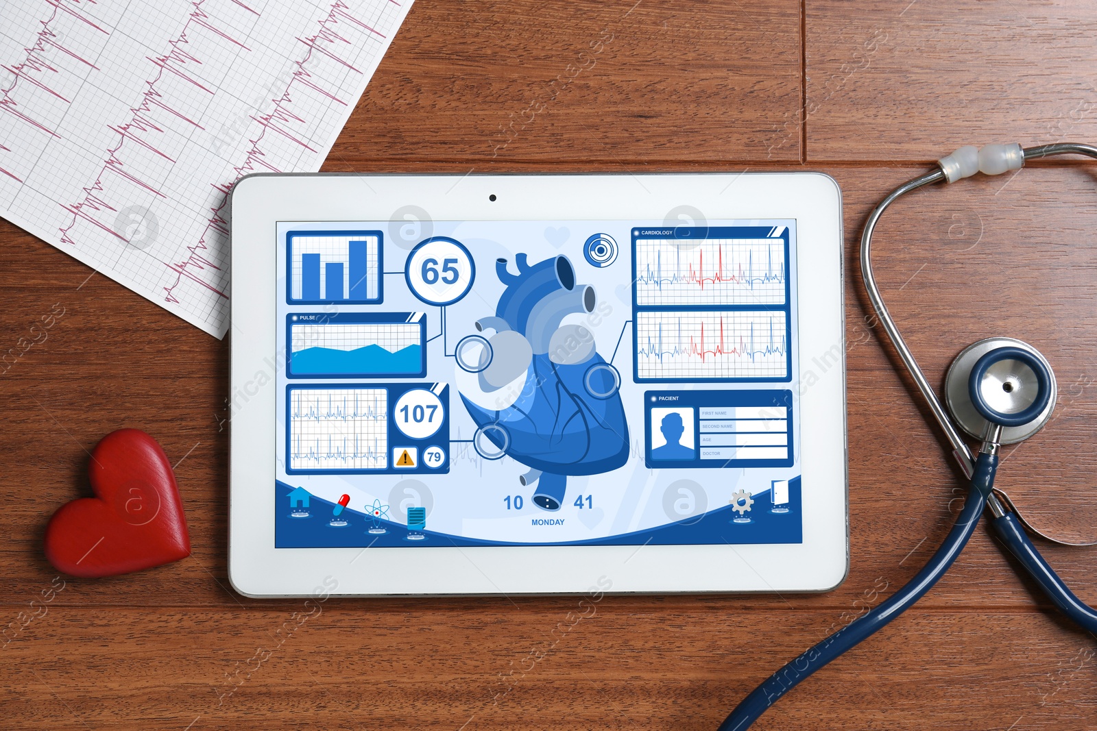 Image of Cardiology. Doctor's workplace with stethoscope and tablet computer on wooden table, top view. Data on device screen