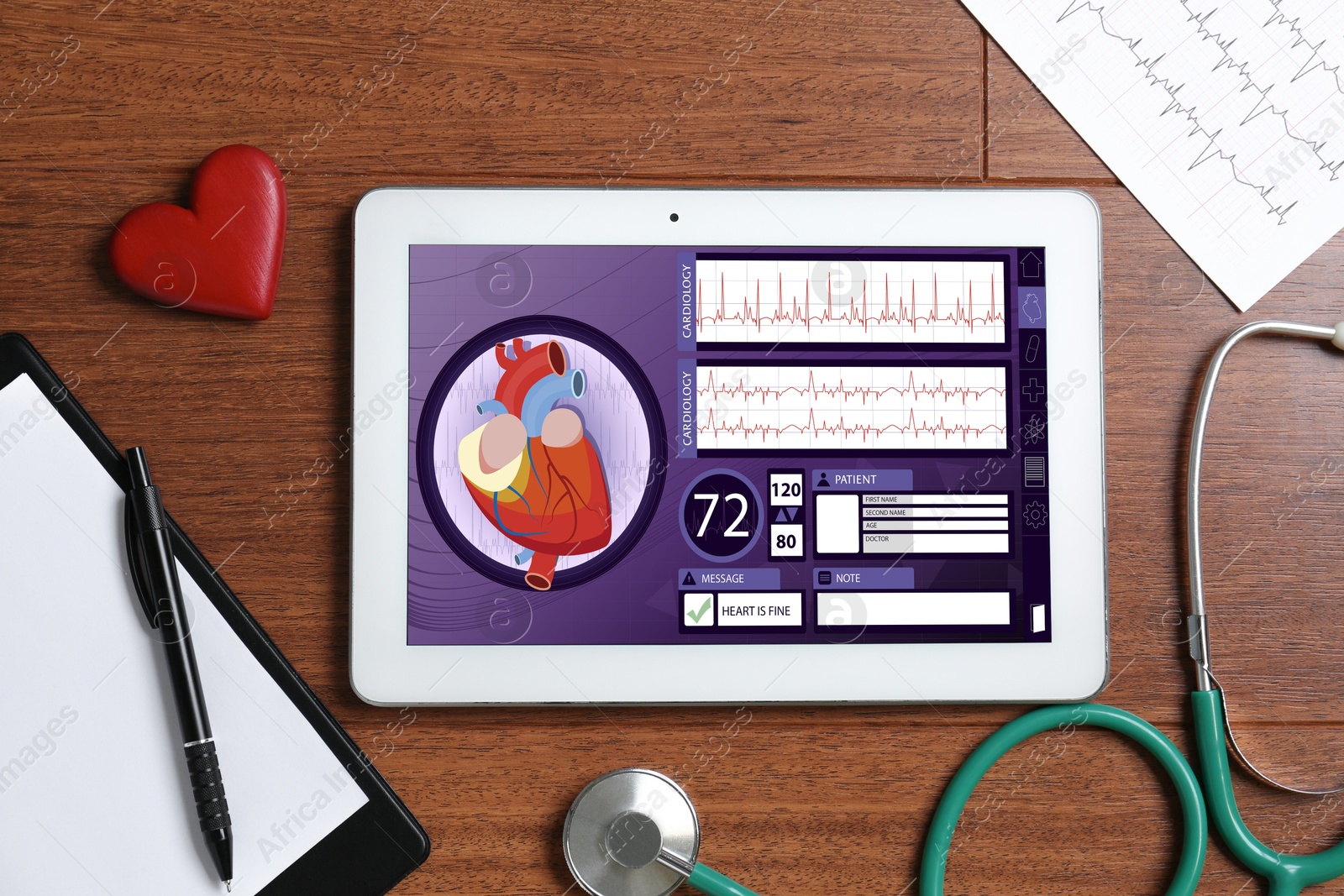 Image of Cardiology. Doctor's workplace with stethoscope and tablet computer on wooden table, top view. Data on device screen