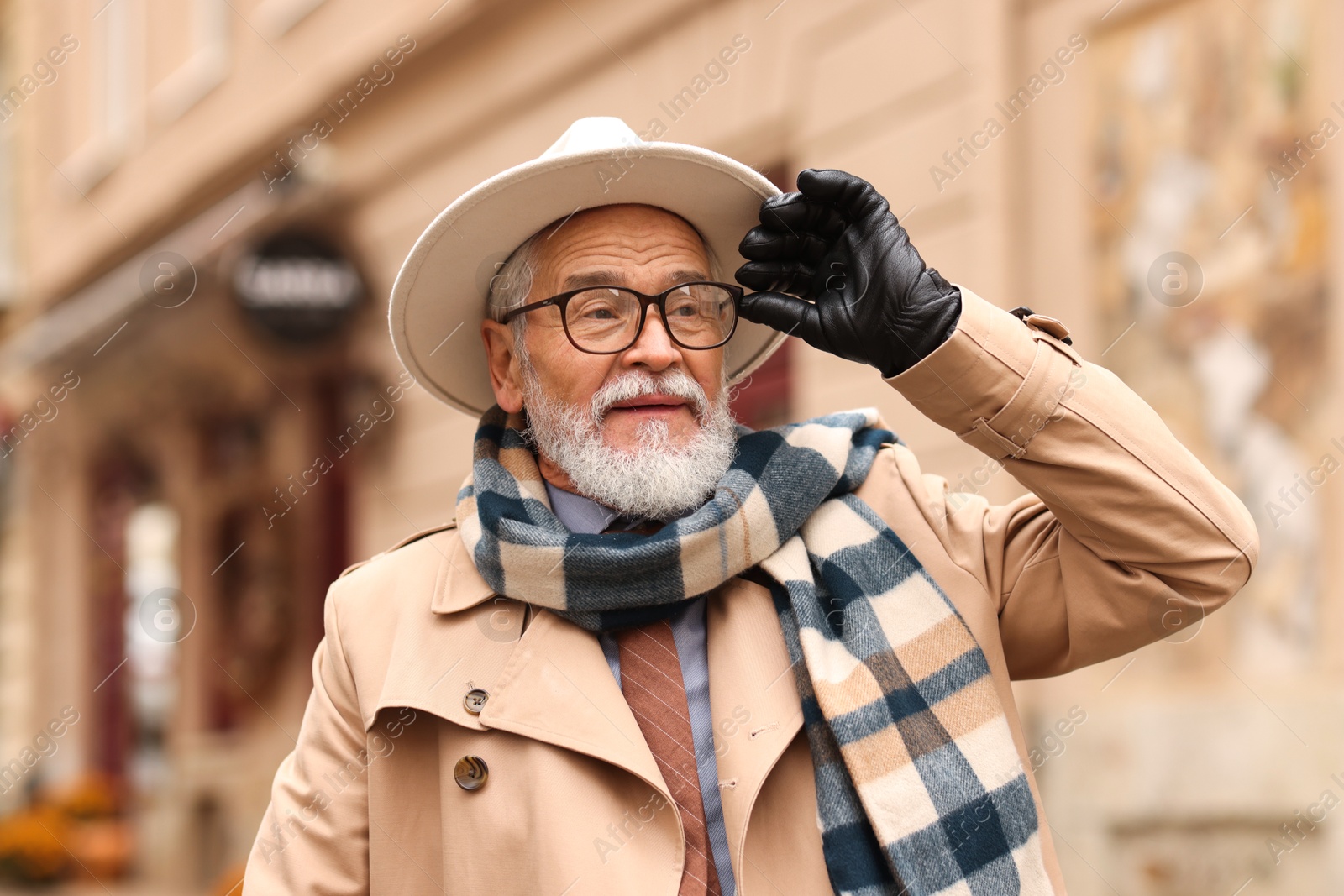 Photo of Stylish bearded senior man on city street