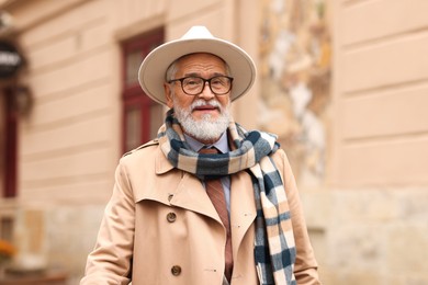 Stylish bearded senior man on city street