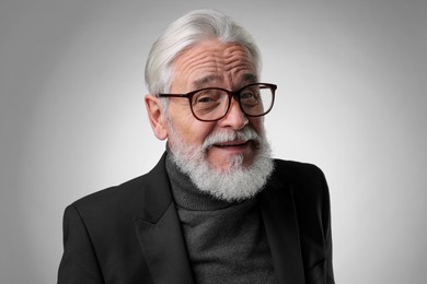 Photo of Portrait of senior man with silver beard on light grey background