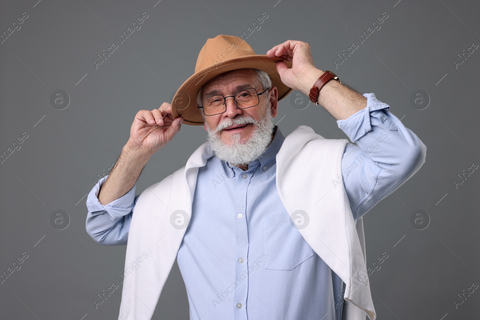 Photo of Bearded senior man with stylish hat on grey background