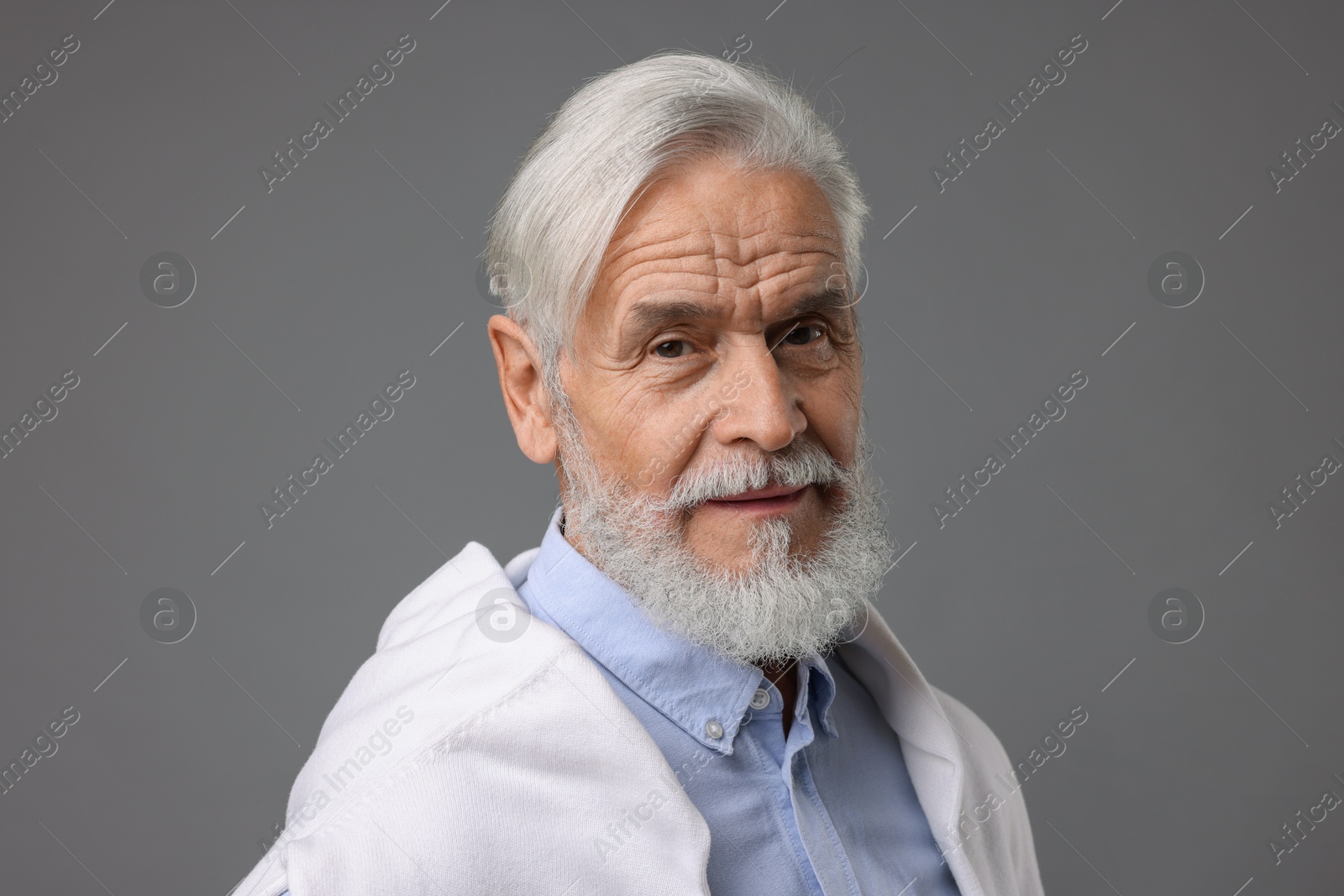 Photo of Portrait of stylish bearded man on grey background