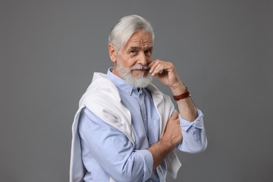 Photo of Portrait of stylish bearded man on grey background