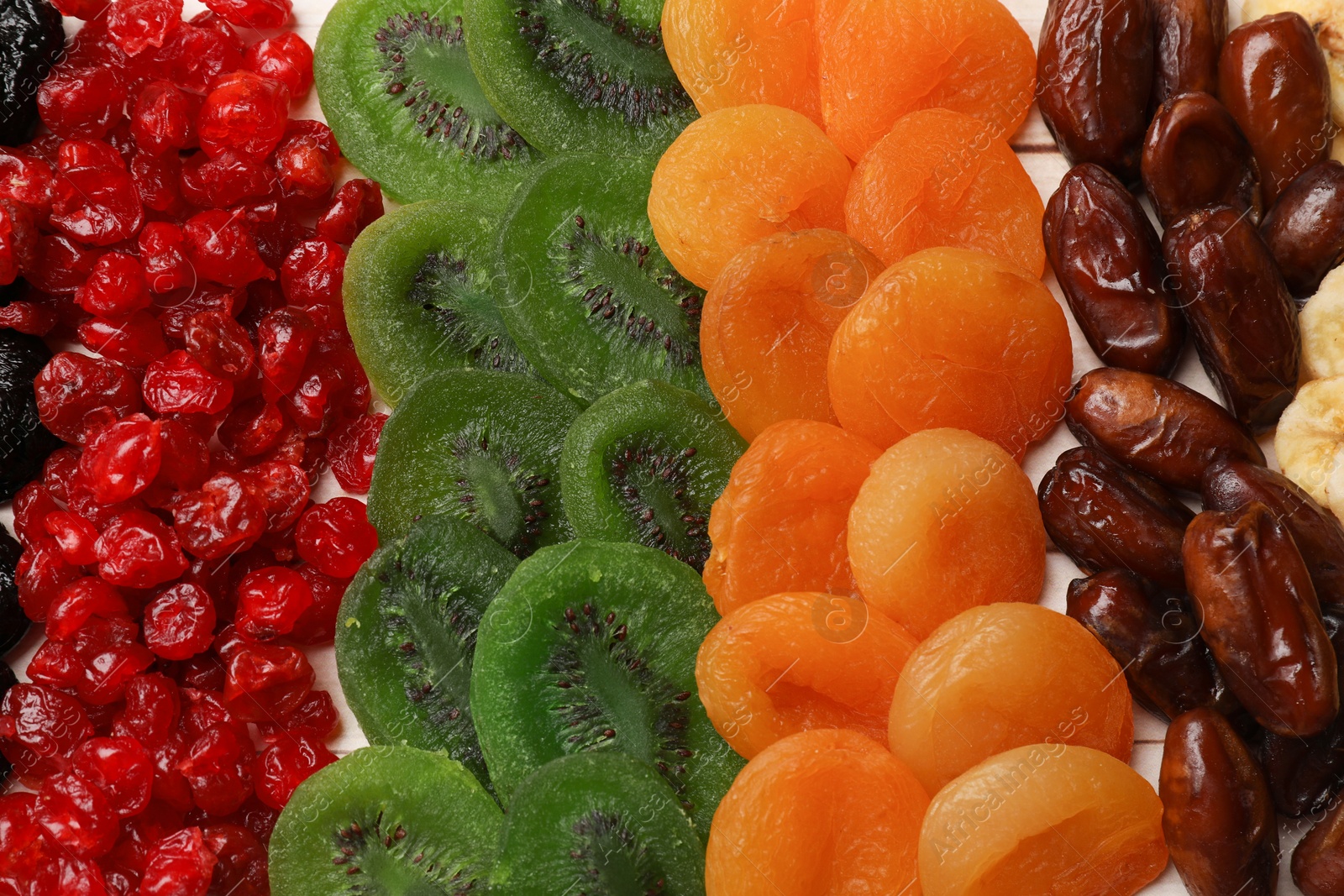 Photo of Mix of different dried fruits on table, top view