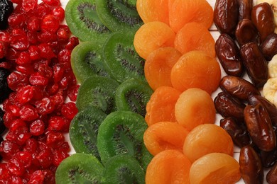 Photo of Mix of different dried fruits on table, top view