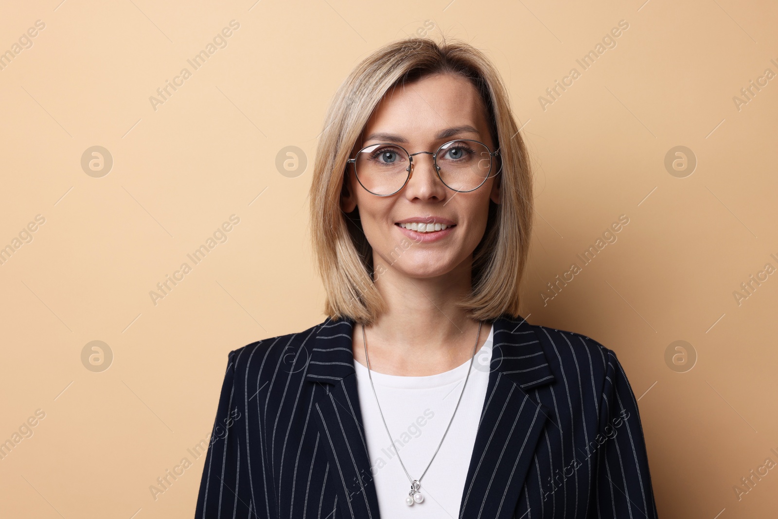 Photo of Portrait of businesswoman in glasses on beige background