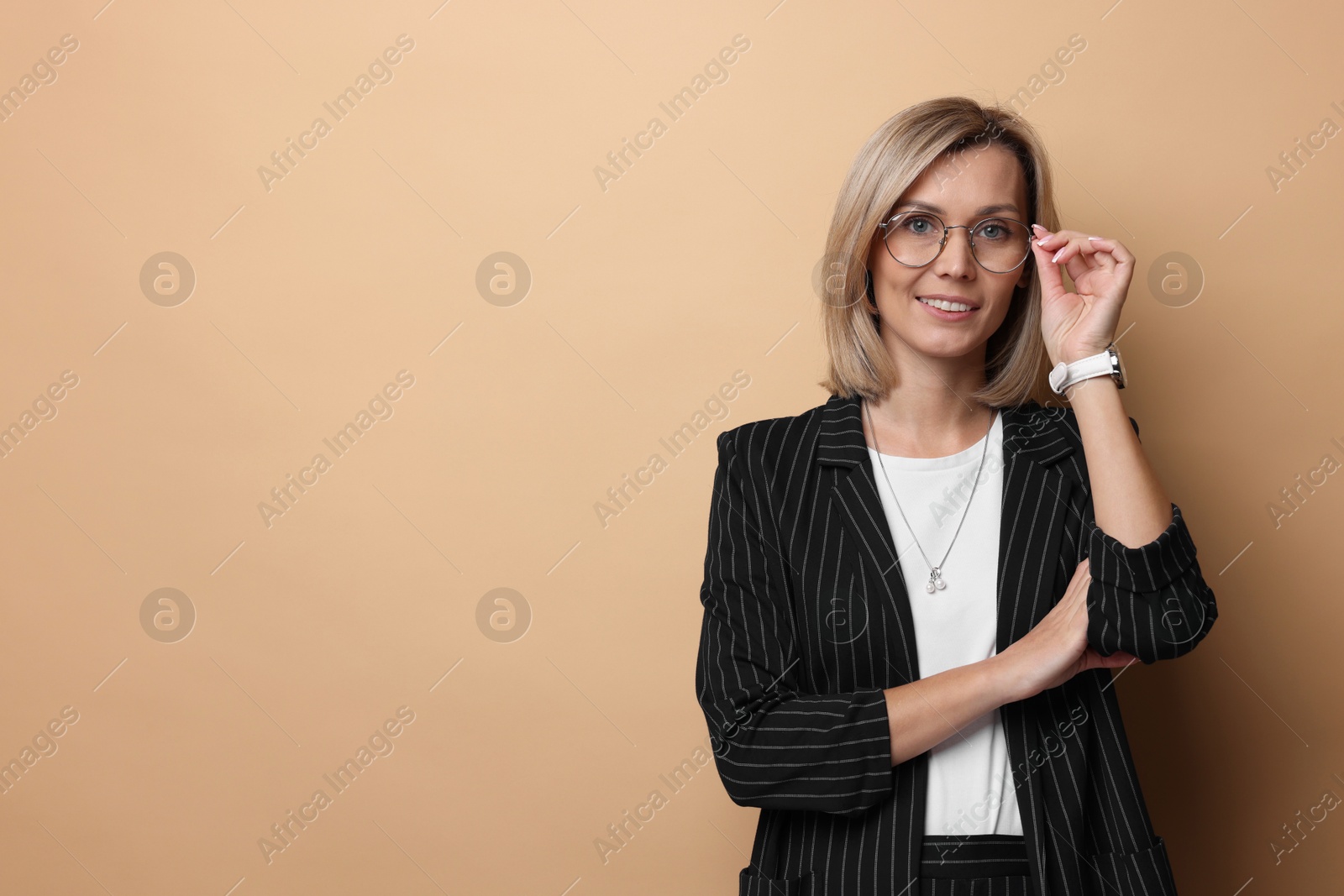 Photo of Portrait of businesswoman in glasses on beige background, space for text