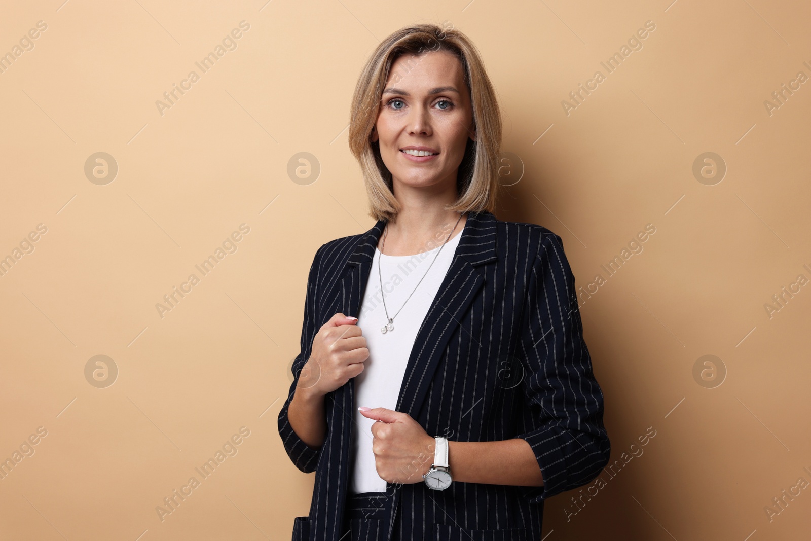 Photo of Portrait of happy businesswoman on beige background