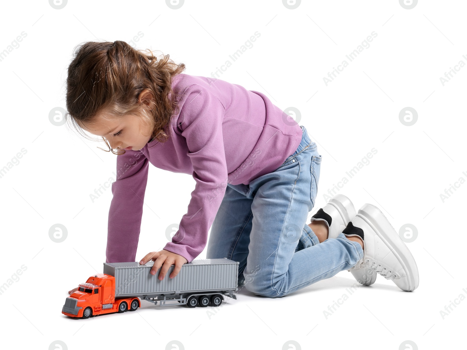 Photo of Little girl playing with toy car on white background