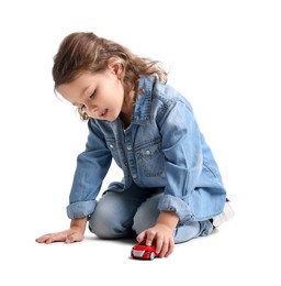 Photo of Little girl playing with toy car on white background