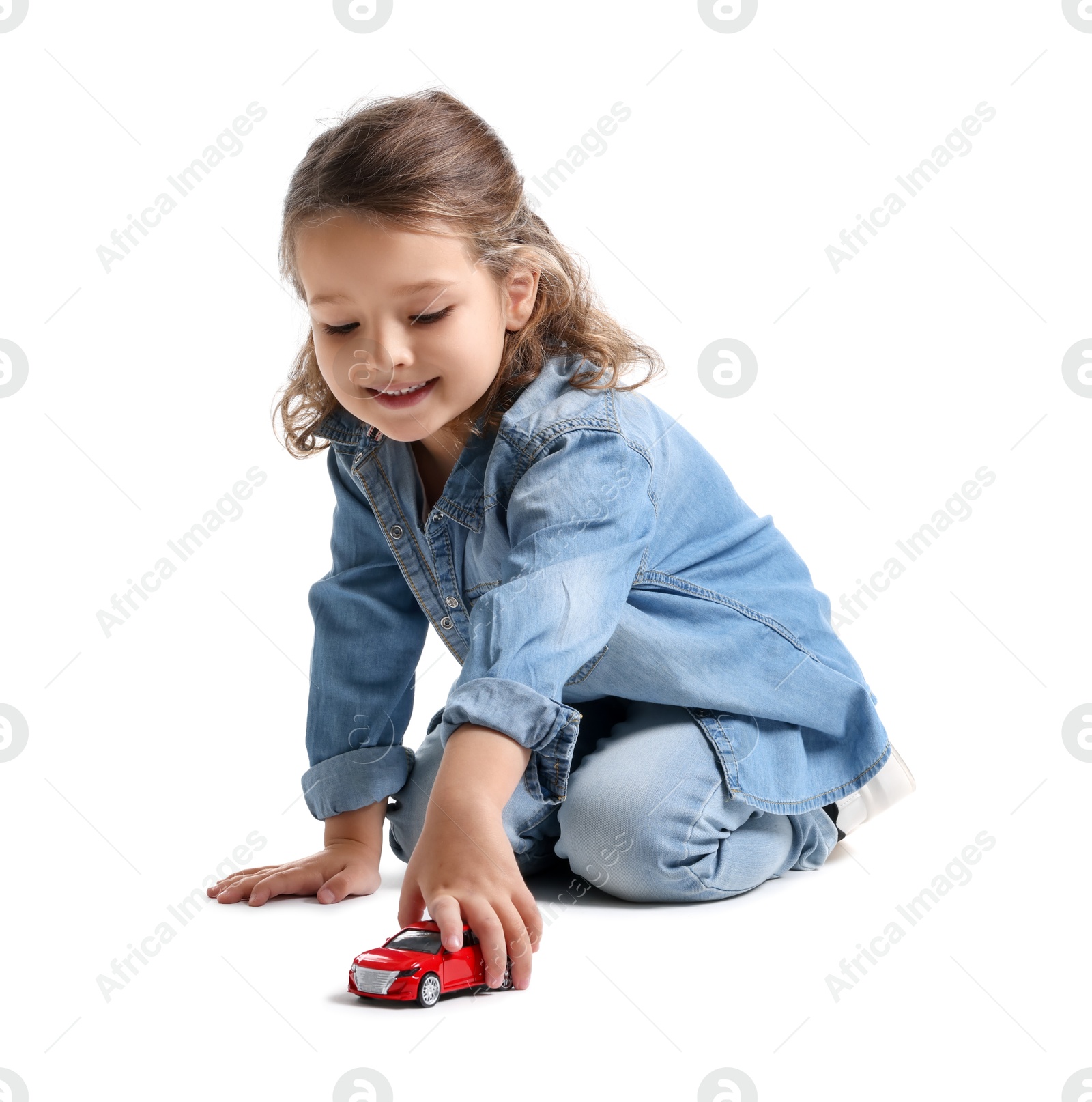 Photo of Little girl playing with toy car on white background