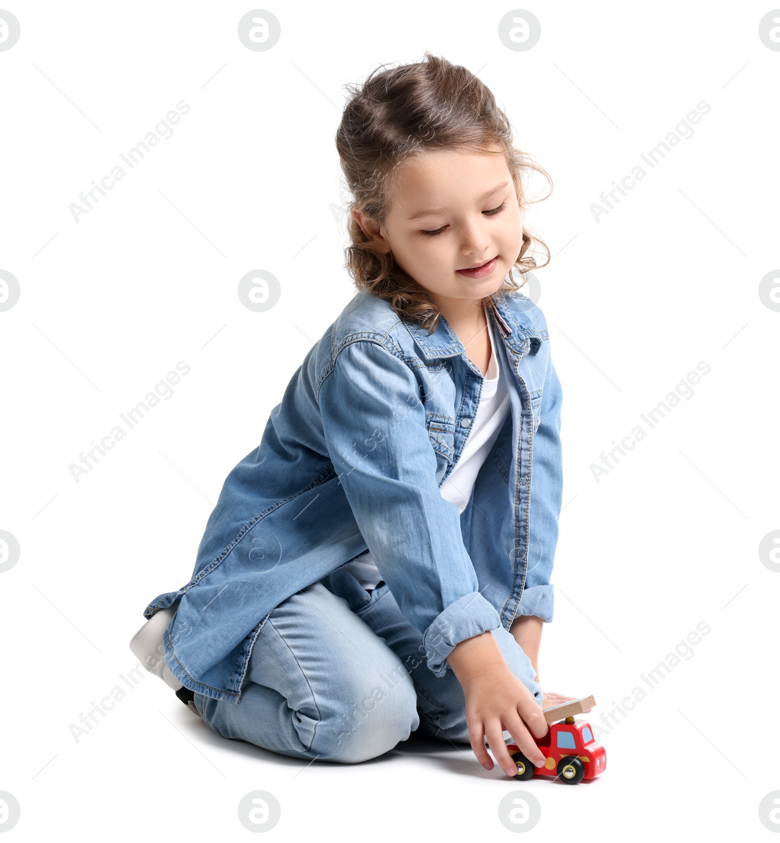 Photo of Little girl playing with toy car on white background