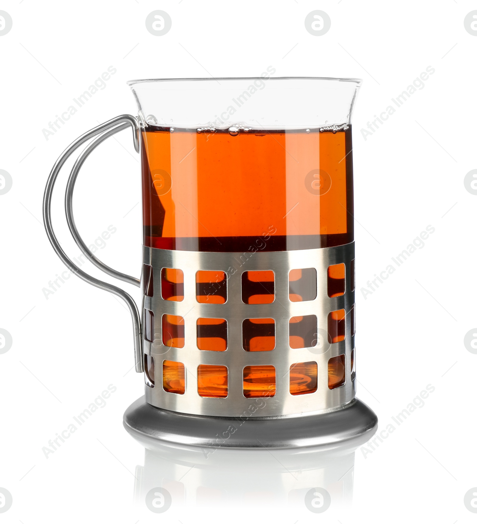 Photo of Glass of aromatic tea in holder isolated on white