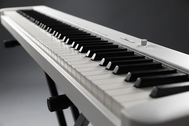 Photo of Synthesizer on grey background, closeup. Electronic musical instrument