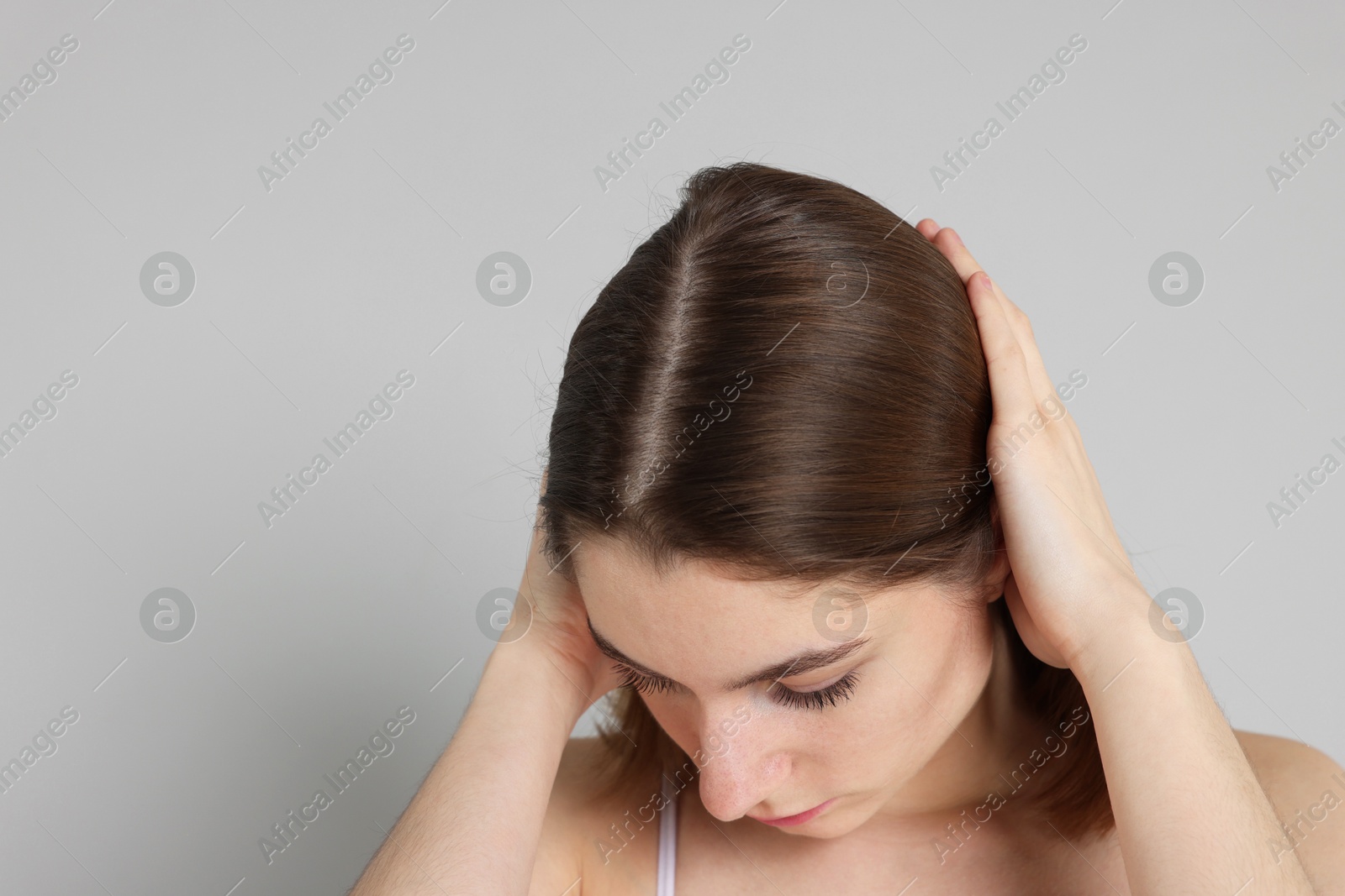 Photo of Girl with hair loss problem on grey background, space for text