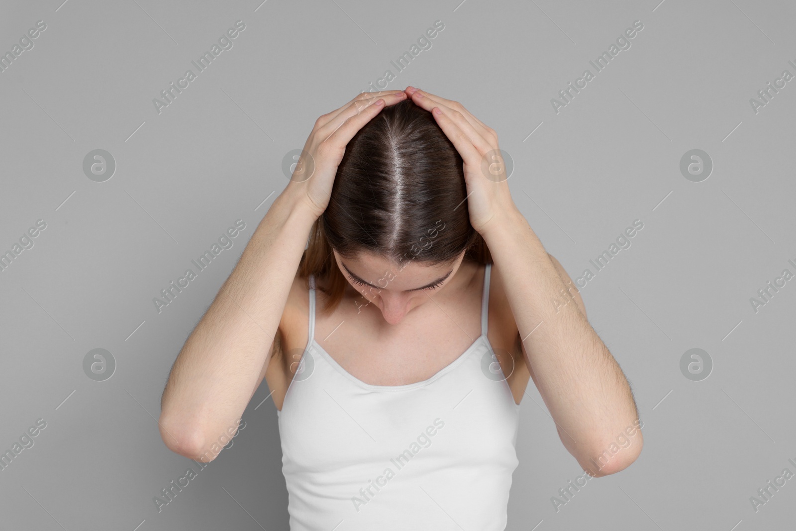 Photo of Girl with hair loss problem on grey background