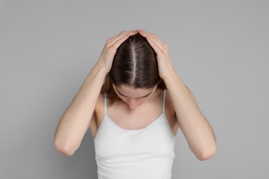 Photo of Girl with hair loss problem on grey background