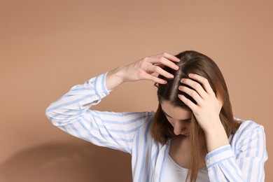 Photo of Girl with hair loss problem on dark beige background