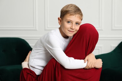 Photo of Muslim woman and her son spending time together at home