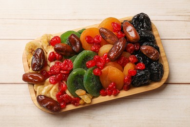 Photo of Different dried fruits on white wooden table, top view