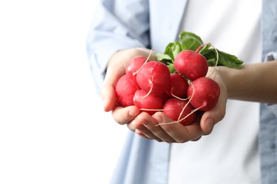 Photo of Woman with bunch of fresh radishes on white background, closeup. Space for text