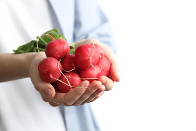 Photo of Woman with bunch of fresh radishes on white background, closeup. Space for text