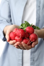 Photo of Woman with bunch of fresh radishes, closeup