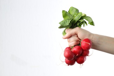 Photo of Woman with bunch of fresh radishes on white background, closeup. Space for text