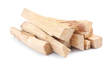 Pile of palo santo sticks on white background