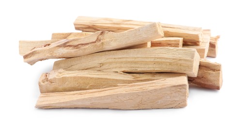 Photo of Pile of palo santo sticks on white background