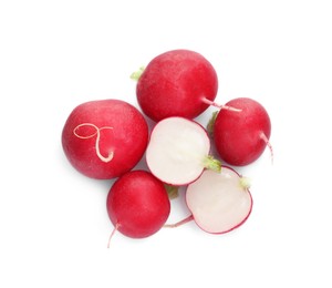 Photo of Whole and cut radishes isolated on white, top view