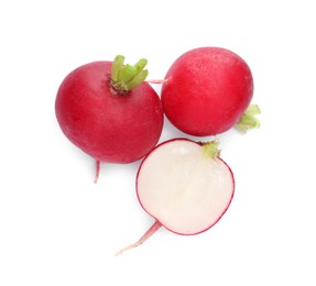 Photo of Whole and cut radishes isolated on white, top view