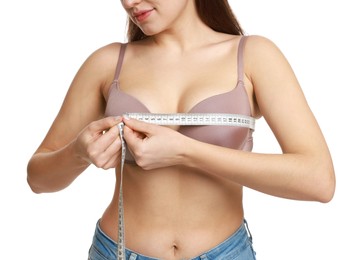 Photo of Woman in beautiful bra measuring breast circumference on white background, closeup