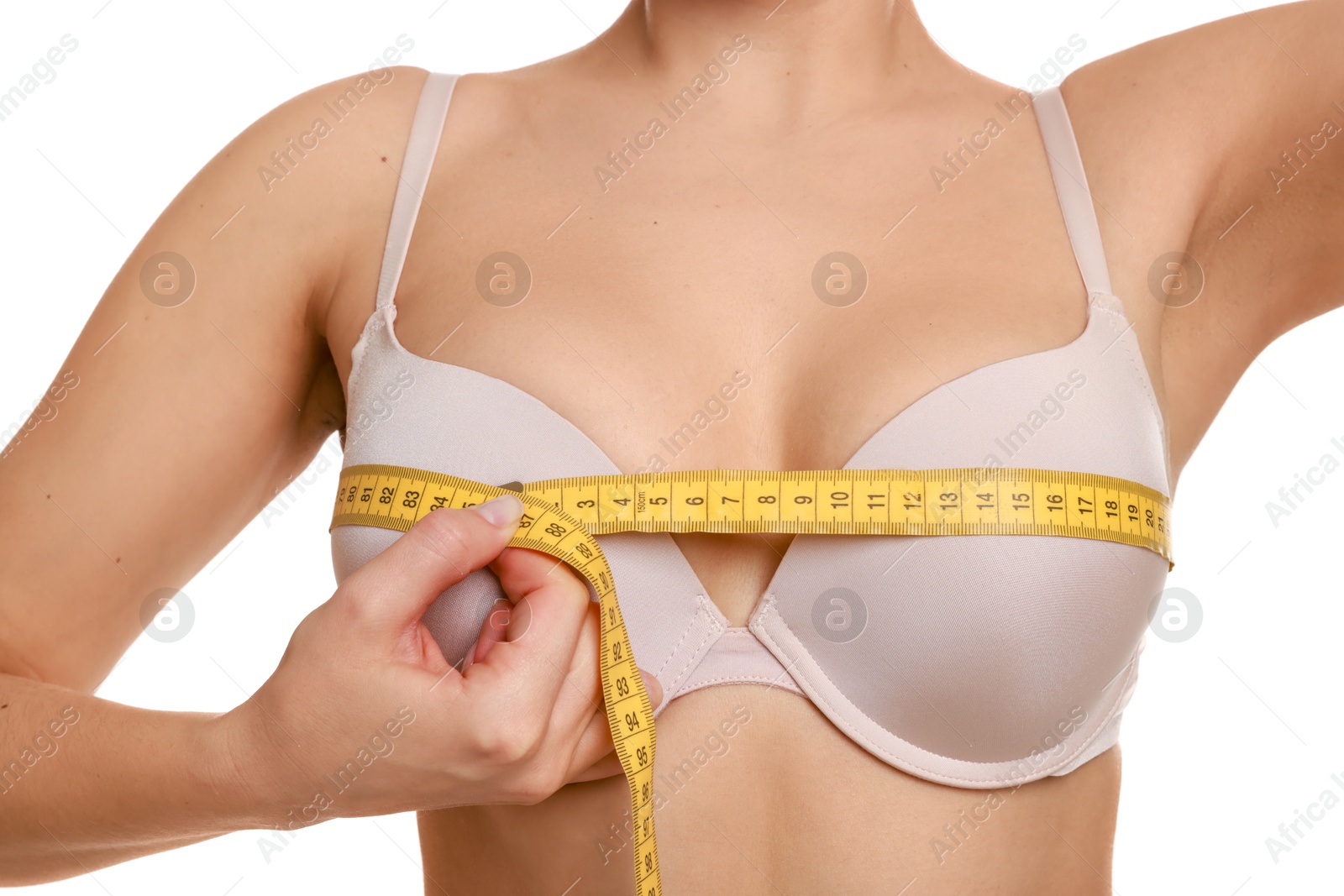 Photo of Woman in beautiful bra measuring breast circumference on white background, closeup