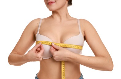 Photo of Woman in beautiful bra measuring breast circumference on white background, closeup