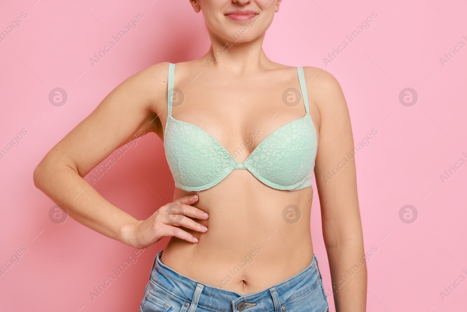 Photo of Woman wearing beautiful bra on pink background, closeup