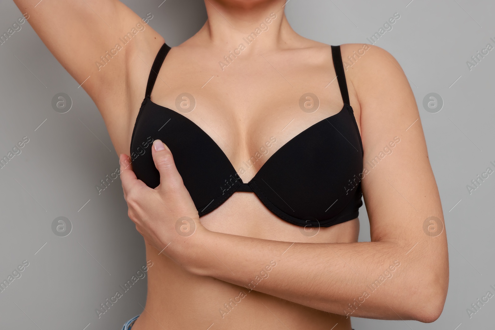 Photo of Woman wearing beautiful bra on light background, closeup