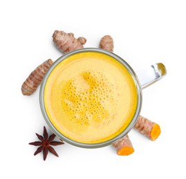 Photo of Delicious turmeric latte in glass cup, roots and anise star isolated on white, top view