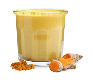 Photo of Delicious turmeric latte in glass, powder and roots isolated on white