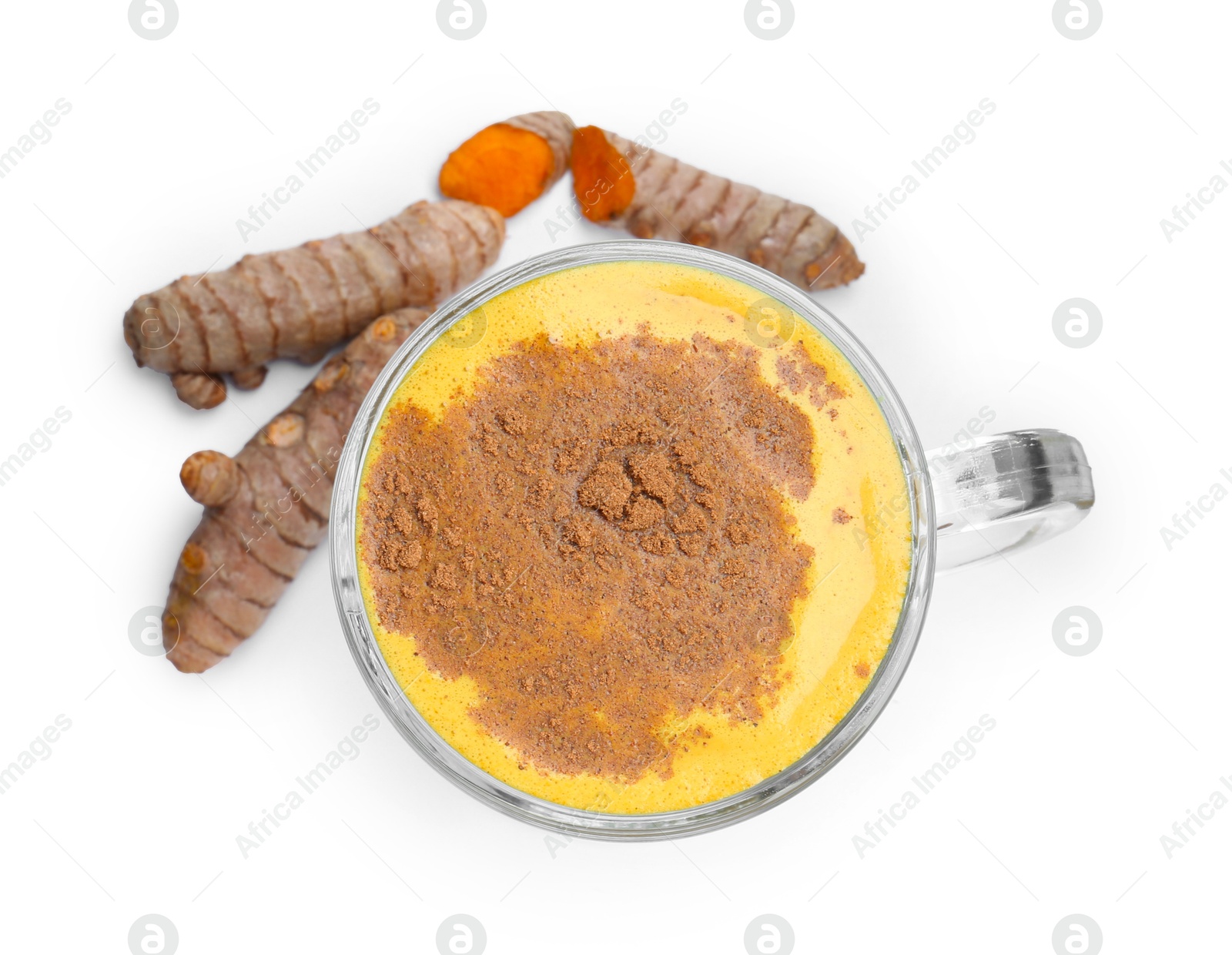 Photo of Delicious turmeric latte in glass cup and roots isolated on white, top view