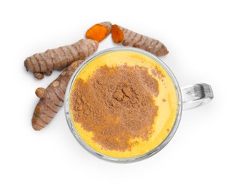 Photo of Delicious turmeric latte in glass cup and roots isolated on white, top view