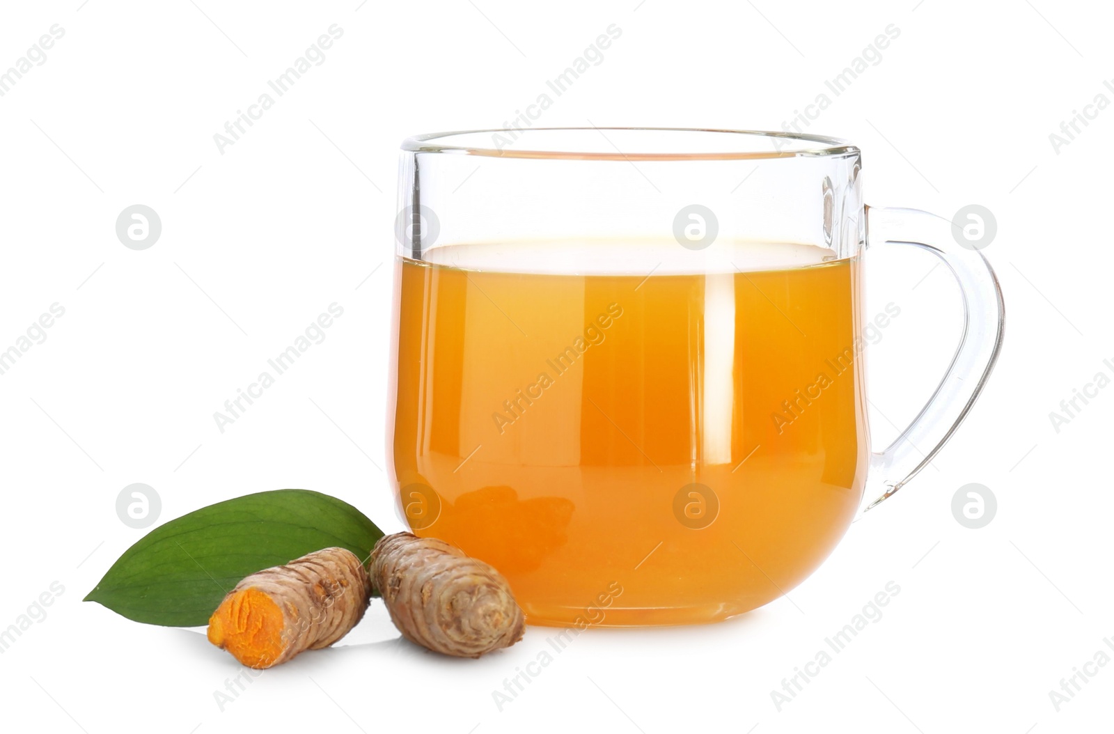 Photo of Aromatic turmeric tea in glass cup, roots and green leaf isolated on white