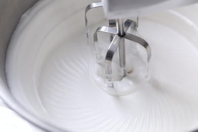 Photo of Mixing whipped cream in bowl of stand mixer, closeup